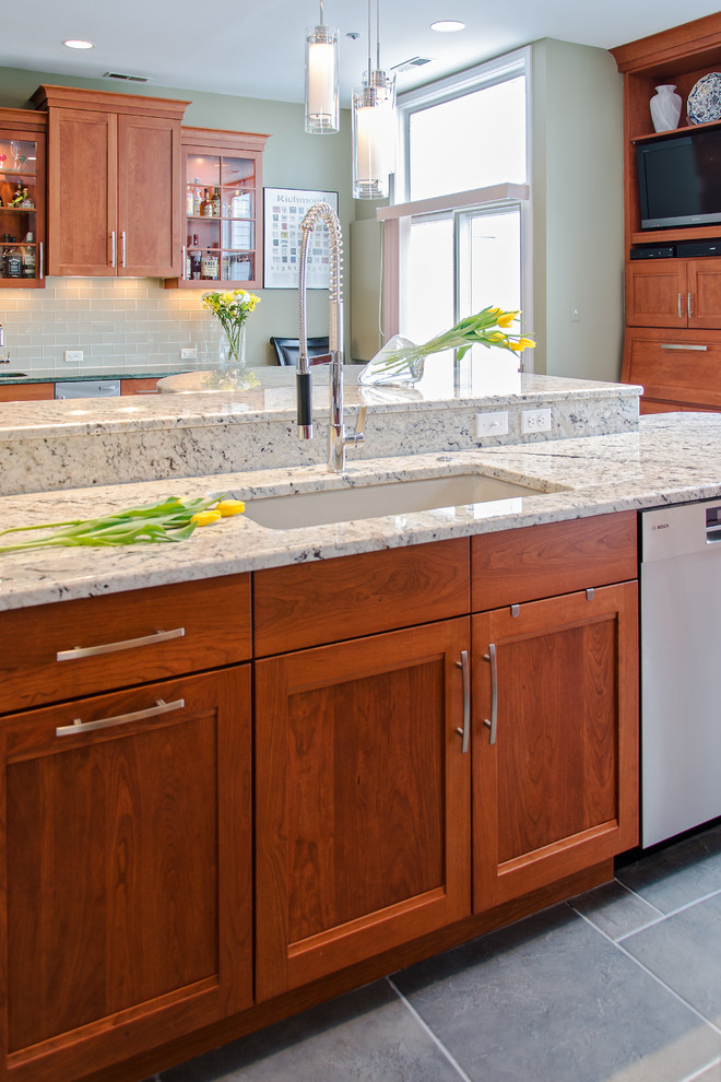 Transitional kitchen photo in Richmond with an undermount sink, flat-panel cabinets, medium tone wood cabinets, granite countertops, beige backsplash, stainless steel appliances and an island