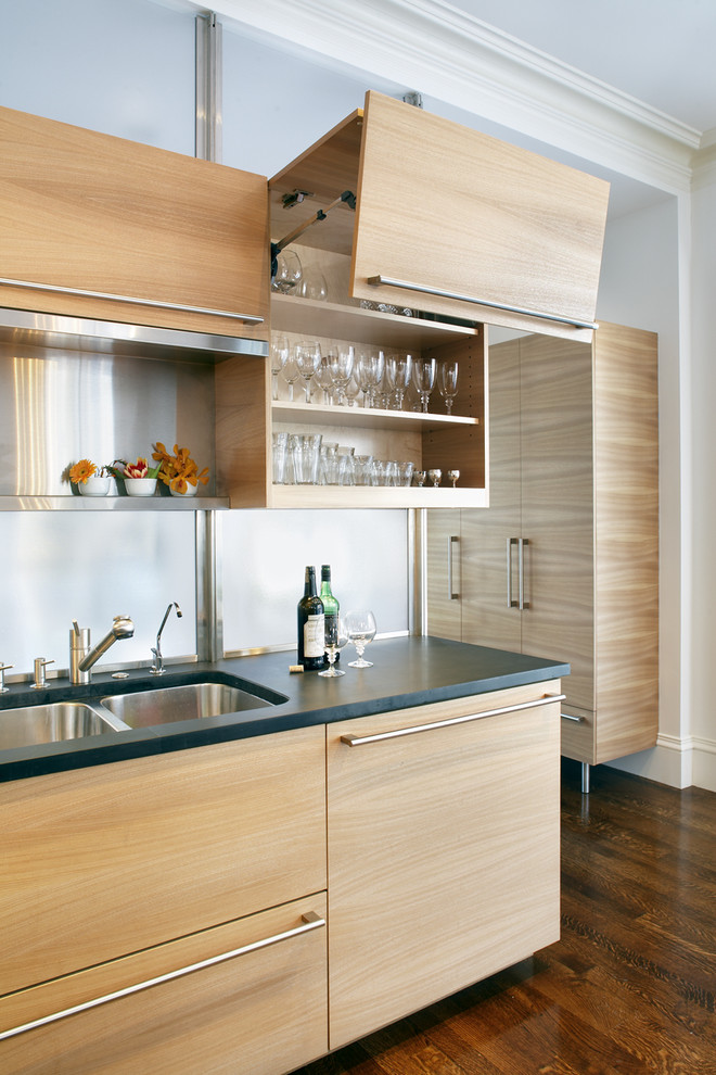 Photo of a contemporary kitchen in Boston with a double-bowl sink, flat-panel cabinets and light wood cabinets.