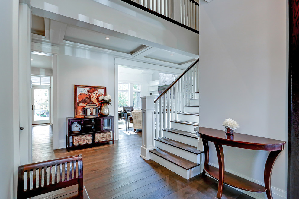 Inspiration for a mid-sized transitional medium tone wood floor and brown floor foyer remodel in Toronto with white walls