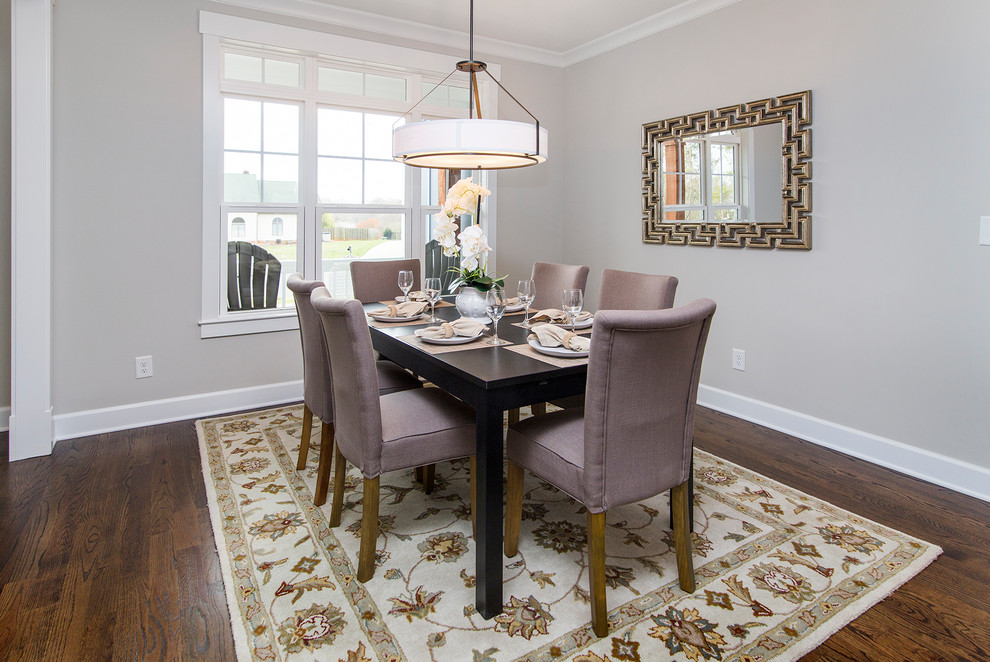 Photo of a transitional dining room in Charlotte with grey walls and dark hardwood floors.