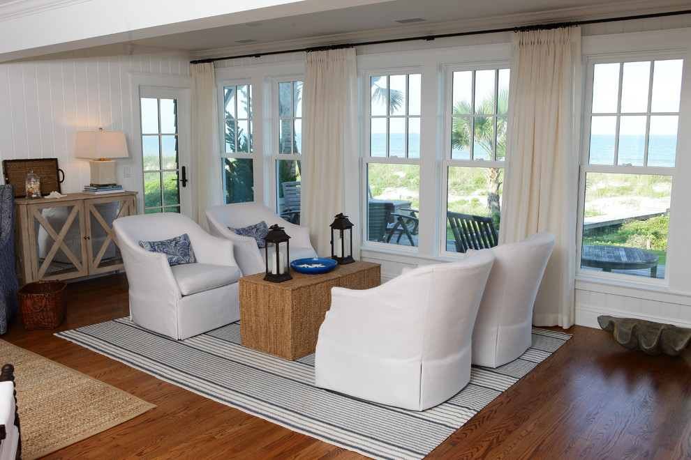 This is an example of a large beach style formal open concept living room in Jacksonville with white walls, medium hardwood floors, no fireplace and no tv.