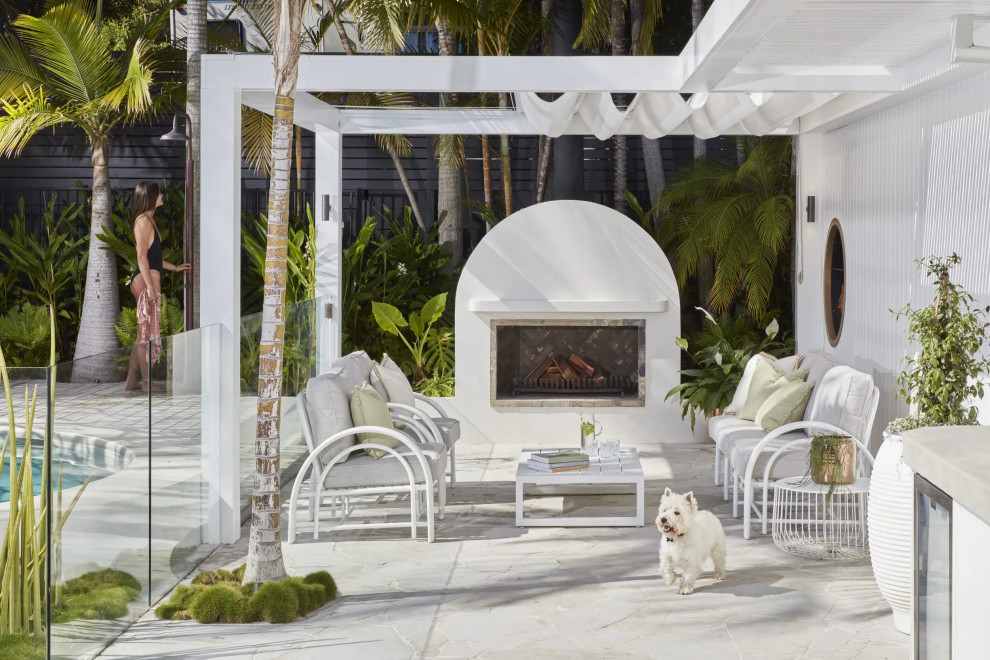 This is an example of a beach style patio in Sydney.