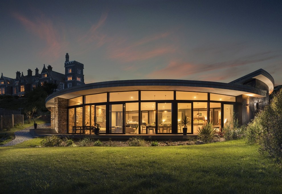 This is an example of a contemporary one-storey glass house exterior in Cornwall.