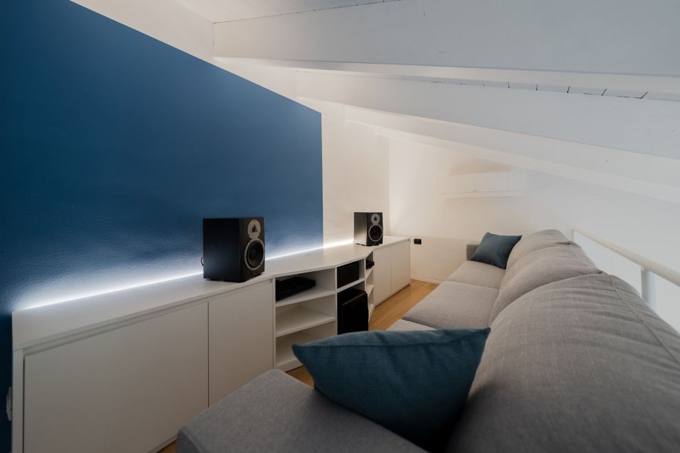 Photo of a small scandinavian open concept family room in Milan with a music area, multi-coloured walls, light hardwood floors, a built-in media wall, beige floor and wood.