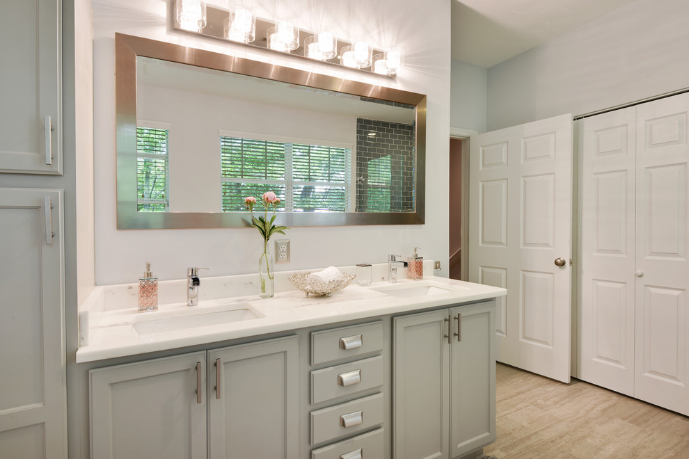 Design ideas for a mid-sized transitional master bathroom in Atlanta with raised-panel cabinets, grey cabinets, an undermount tub, an open shower, a one-piece toilet, blue tile, glass tile, grey walls, porcelain floors, an undermount sink, quartzite benchtops, grey floor, a hinged shower door and white benchtops.