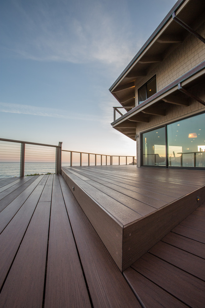 This is an example of a large contemporary deck in San Francisco with a roof extension.