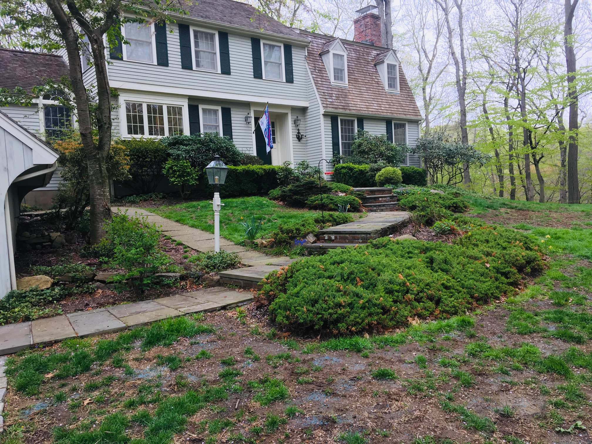 Client requested we replaced old falling apart front door walkway with a new flagstone and tread walkway at 4 feet wide. The risers are stacked frield stone to keep the theme country. The path by the