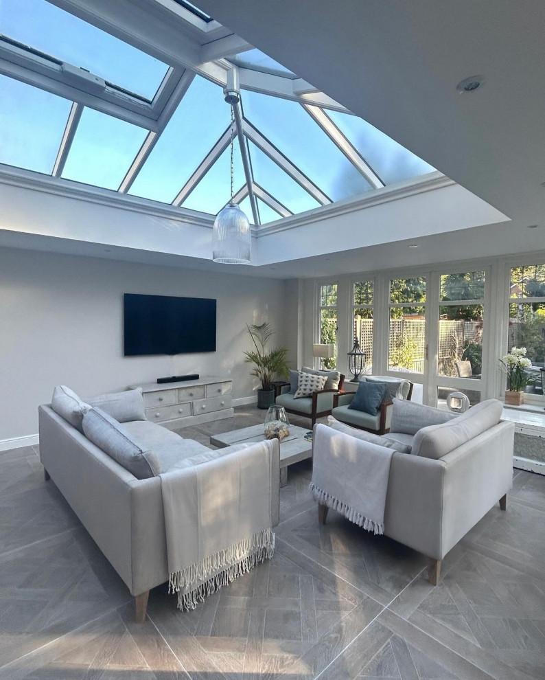 Inspiration for a large nautical conservatory in Surrey with light hardwood flooring, no fireplace, a skylight and grey floors.