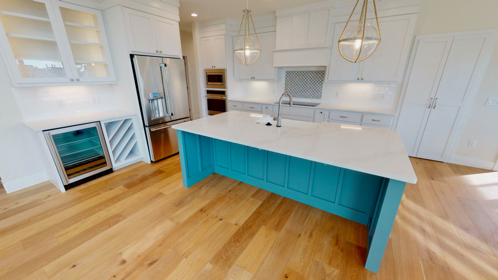 Kitchen - kitchen idea with blue cabinets, white backsplash, subway tile backsplash and white countertops