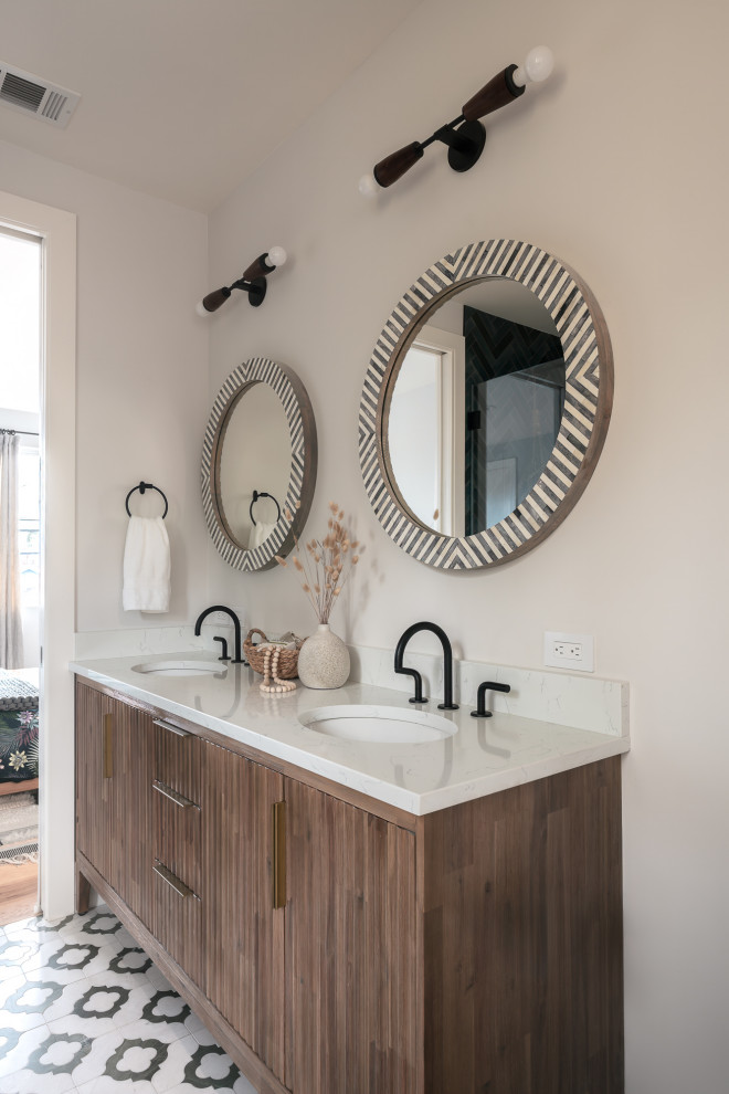 Photo of a mid-sized eclectic master bathroom in San Francisco with furniture-like cabinets, medium wood cabinets, a freestanding tub, an alcove shower, a one-piece toilet, green tile, porcelain tile, white walls, marble floors, an undermount sink, engineered quartz benchtops, green floor, a hinged shower door, white benchtops, a niche, a double vanity and a freestanding vanity.