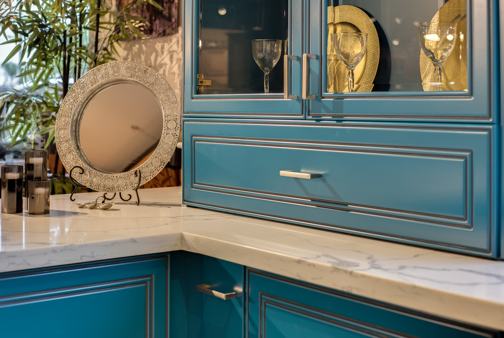 Small beach style galley eat-in kitchen in Orange County with a farmhouse sink, glass-front cabinets, blue cabinets, quartz benchtops, grey splashback and ceramic splashback.