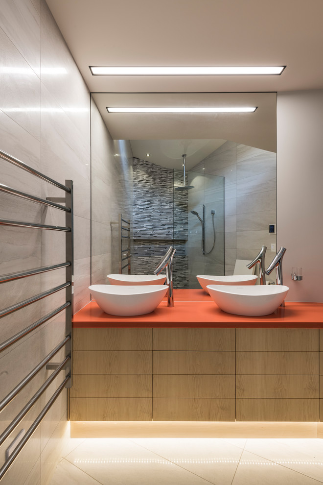 Photo of an asian master bathroom in Christchurch with flat-panel cabinets, light wood cabinets, an open shower, grey walls, a vessel sink, beige floor, an open shower and orange benchtops.