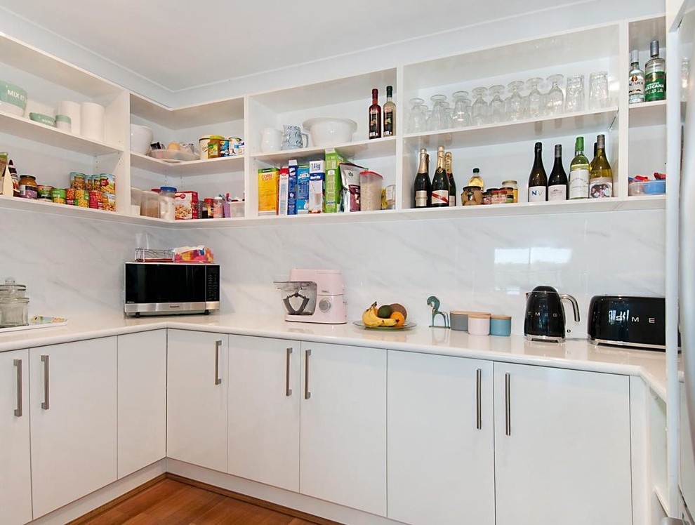 Photo of a contemporary kitchen pantry in Other with porcelain splashback.
