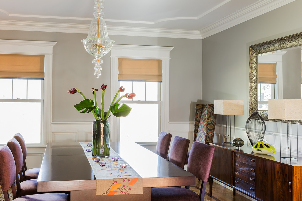 This is an example of a transitional separate dining room in Boston with grey walls, medium hardwood floors and no fireplace.