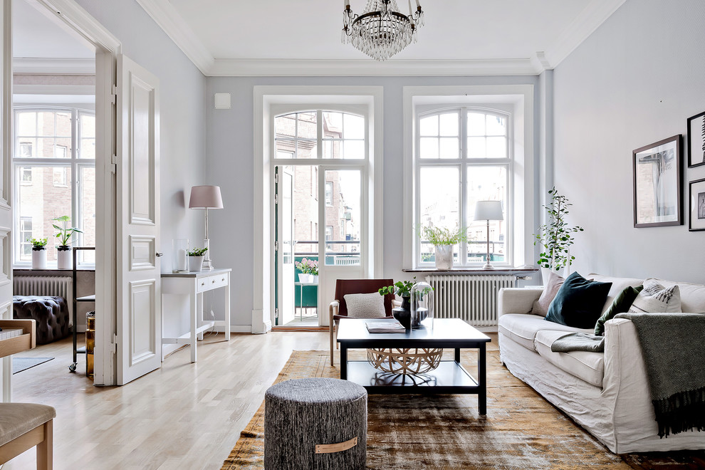 This is an example of a mid-sized scandinavian enclosed living room in Gothenburg with grey walls, light hardwood floors and beige floor.