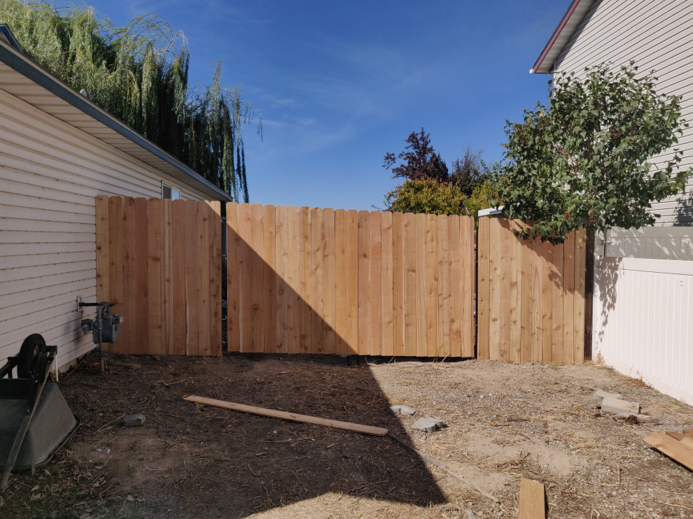 Photo of a traditional private garden in Boise with a wood fence.