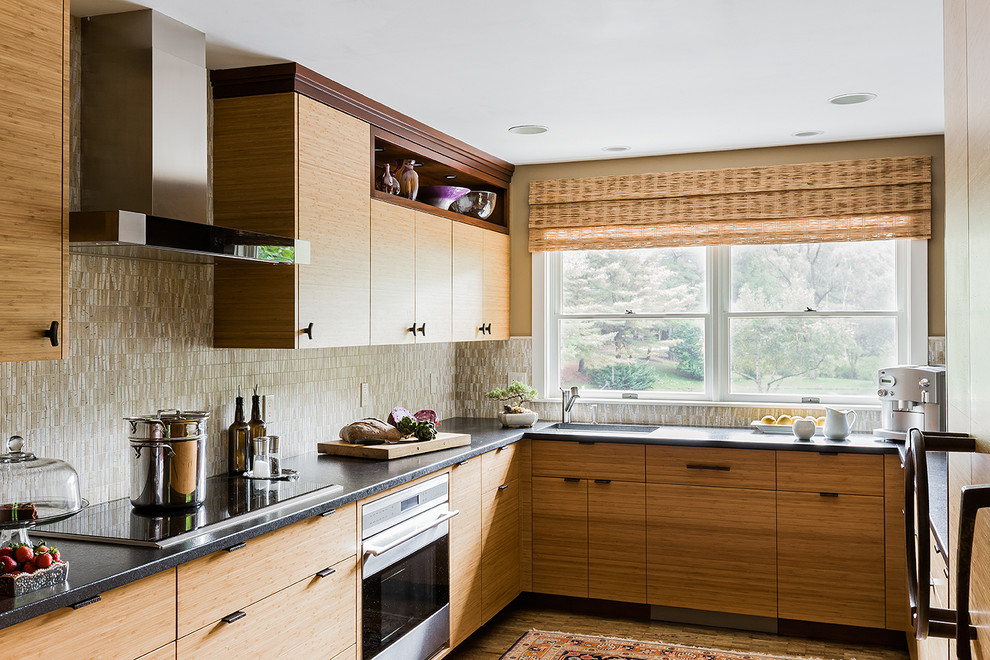 This is an example of an asian u-shaped separate kitchen in Boston with flat-panel cabinets and medium wood cabinets.