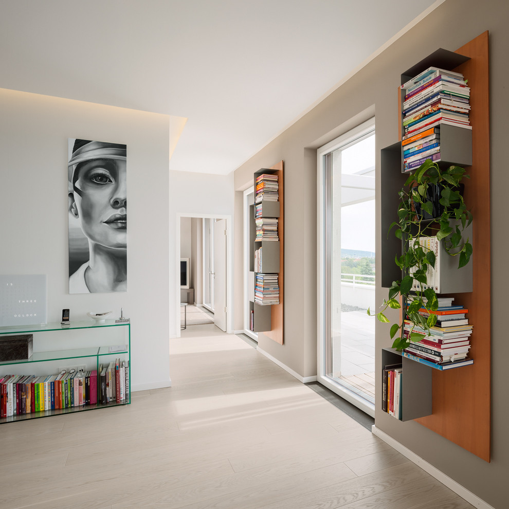 Design ideas for a mid-sized contemporary hallway in Berlin with light hardwood floors and white walls.