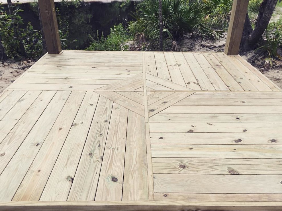 Mid-sized mountain style backyard deck photo in Miami with a roof extension