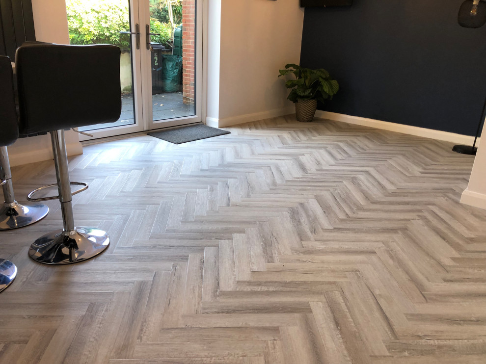 This is an example of a modern kitchen/diner in Devon with vinyl flooring and beige floors.