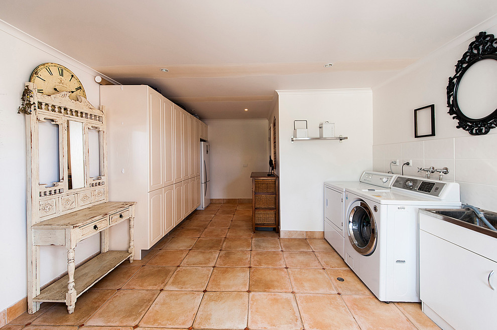 Design ideas for a large contemporary galley dedicated laundry room in Perth with a single-bowl sink, white walls and a side-by-side washer and dryer.