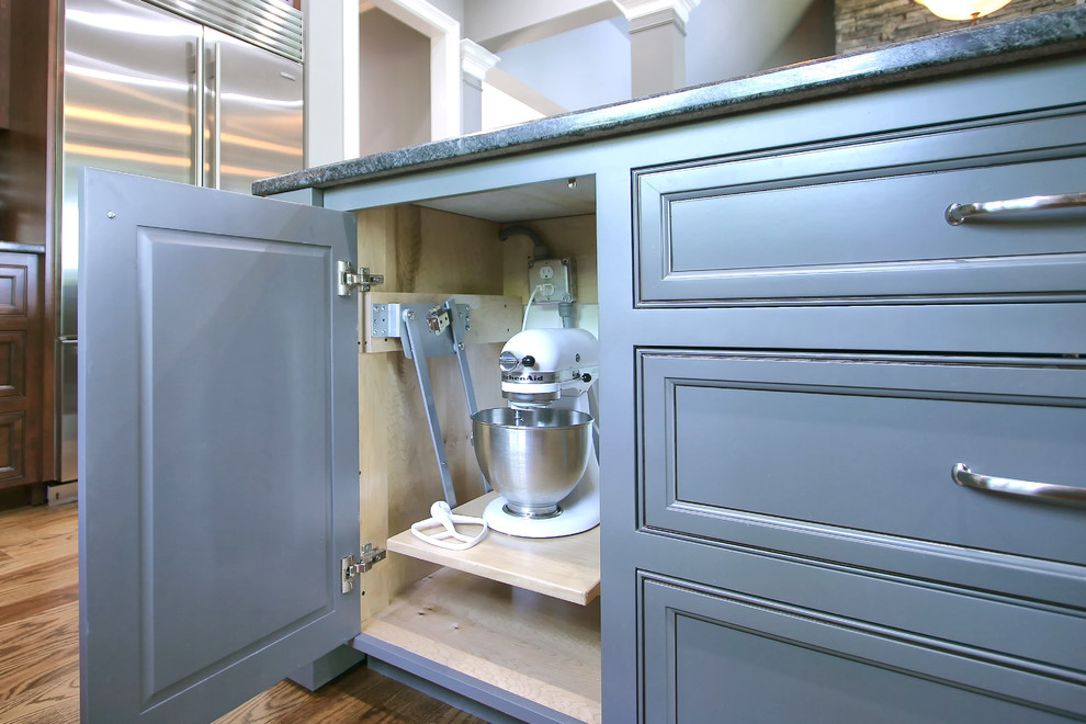 Large transitional medium tone wood floor eat-in kitchen photo in Charlotte with an undermount sink, flat-panel cabinets, stainless steel appliances and an island