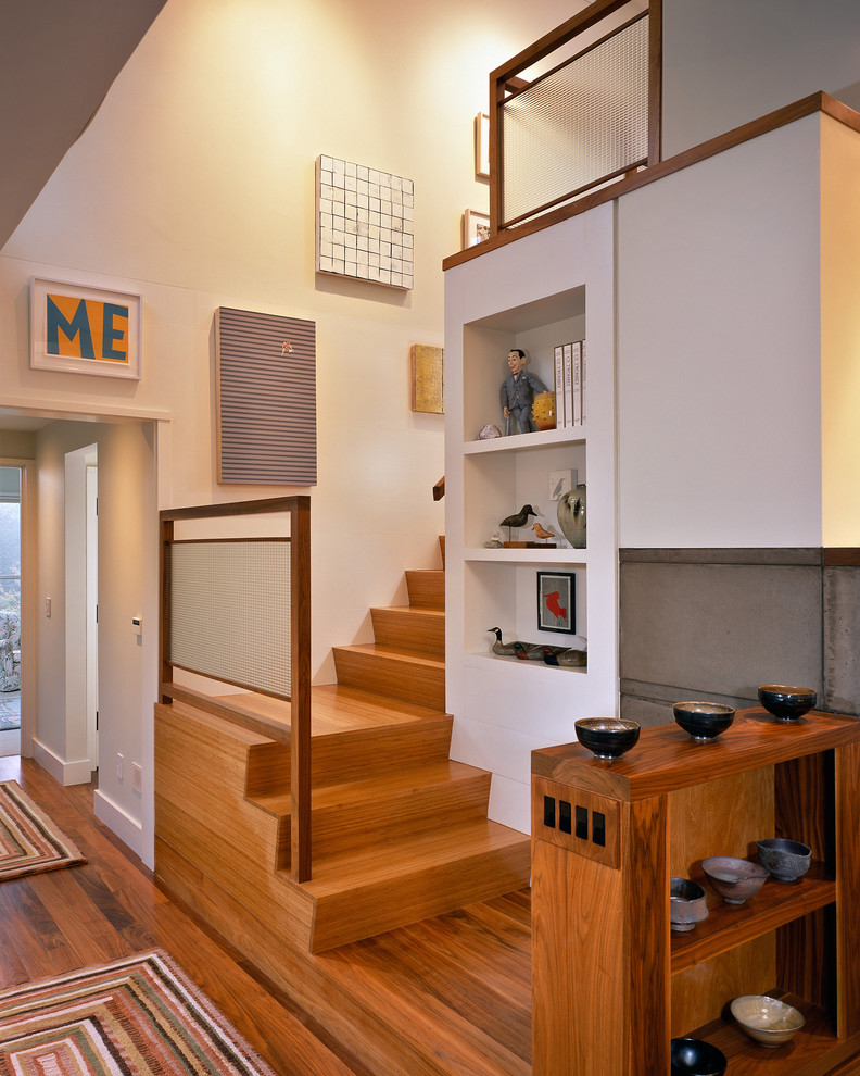 This is an example of a large eclectic wood staircase in Boston with wood risers.