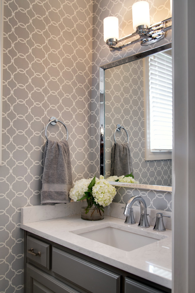 Design ideas for a mid-sized transitional powder room in Kansas City with raised-panel cabinets, grey cabinets, grey walls, dark hardwood floors, an undermount sink and engineered quartz benchtops.
