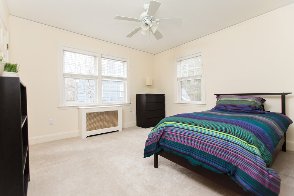 Design ideas for a large traditional master bedroom in Boston with beige walls and carpet.