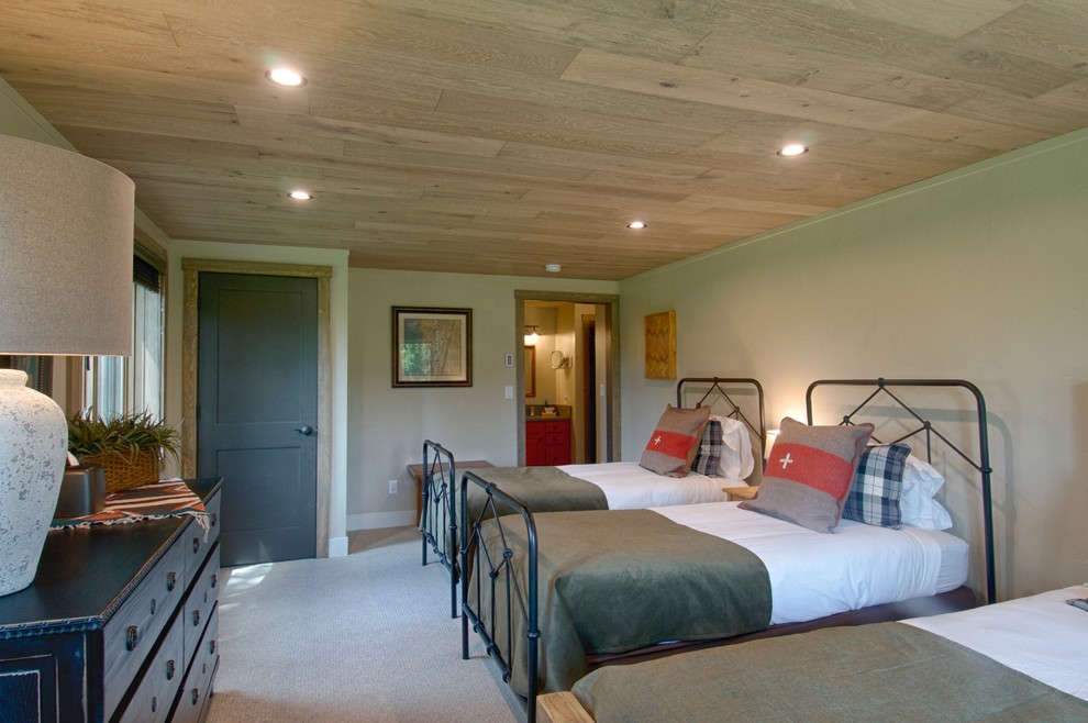 Design ideas for a mid-sized country guest bedroom in Denver with carpet and beige floor.