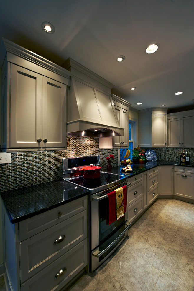 Eat-in kitchen - mid-sized transitional eat-in kitchen idea in Philadelphia with a farmhouse sink, light wood cabinets, multicolored backsplash, stainless steel appliances and an island