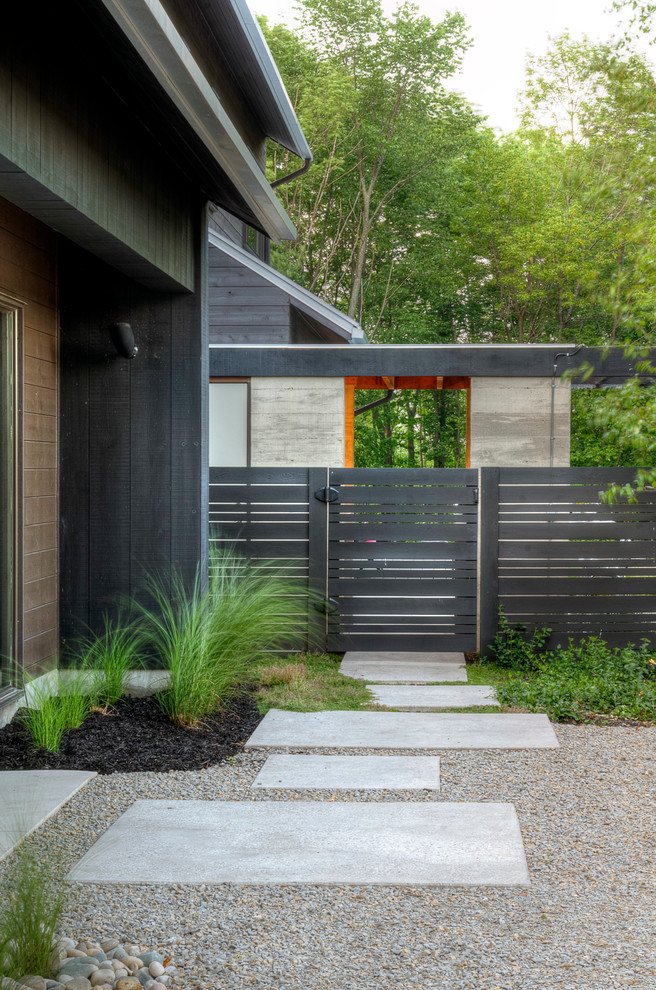 This is an example of a contemporary backyard formal garden in Toronto with gravel.