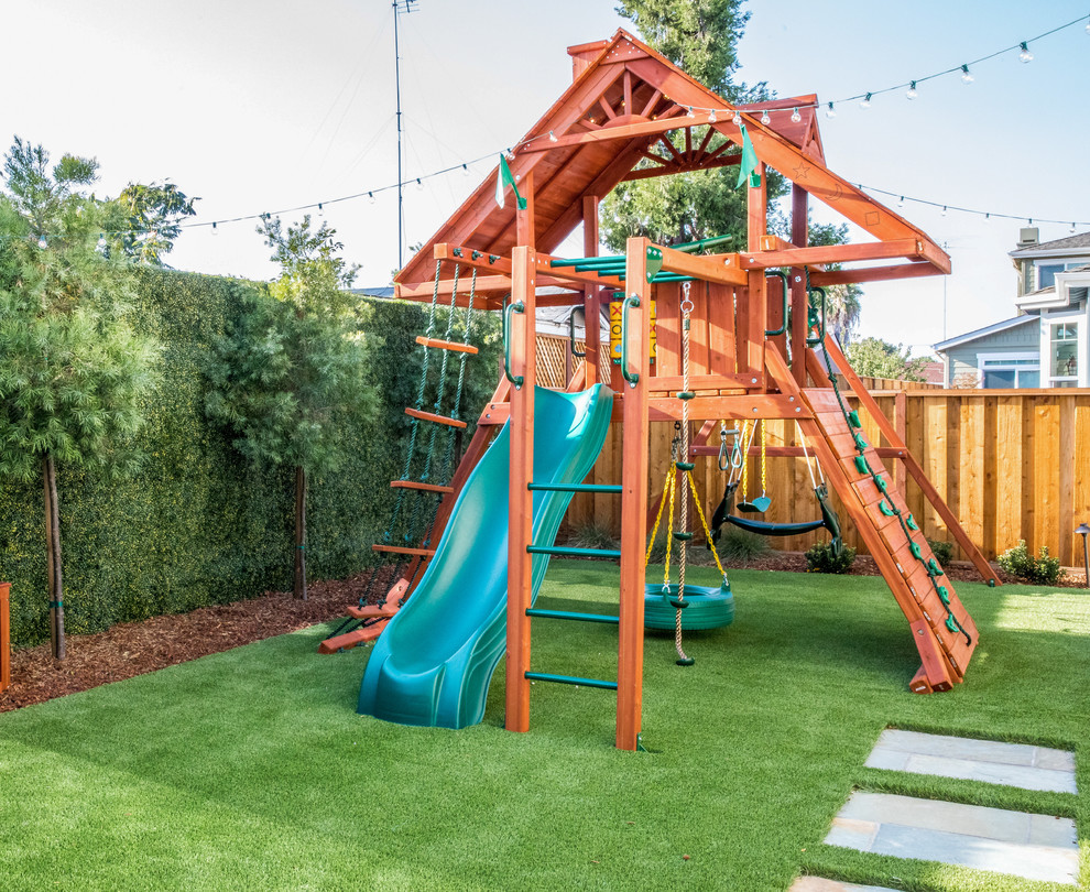 Design ideas for a transitional backyard garden in Richmond with with outdoor playset and a wood fence.