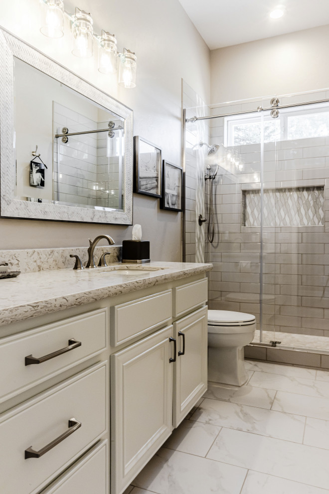 Bathroom - large cottage master gray tile and subway tile ceramic tile, white floor and single-sink bathroom idea in Phoenix with raised-panel cabinets, white cabinets, a two-piece toilet, gray walls, an undermount sink, quartz countertops, white countertops, a niche and a built-in vanity