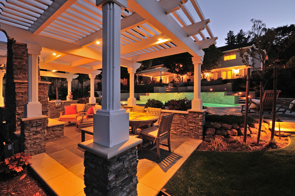 Inspiration for a large traditional backyard patio in San Francisco with a fire feature, tile and a pergola.