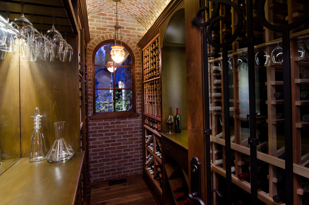 Photo of a small mediterranean wine cellar in Portland with dark hardwood floors and storage racks.