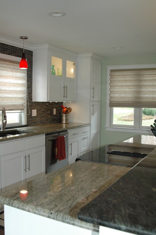 Enclosed kitchen - mid-sized transitional l-shaped medium tone wood floor and brown floor enclosed kitchen idea in Boston with recessed-panel cabinets, white cabinets, multicolored backsplash, an island, an undermount sink, granite countertops, glass tile backsplash and stainless steel appliances