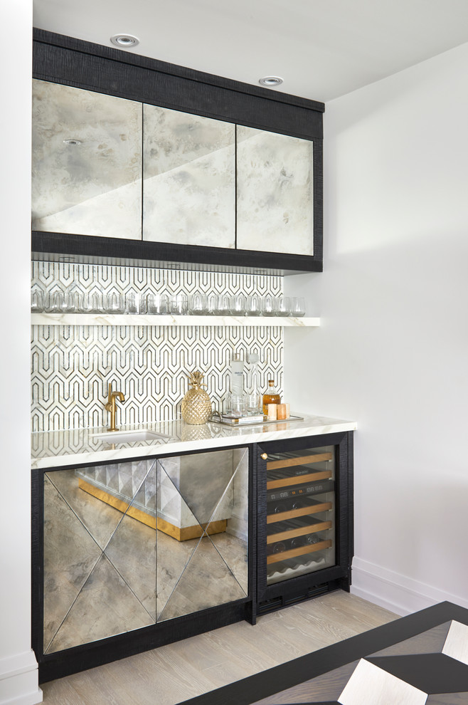 This is an example of a transitional single-wall wet bar in Toronto with an undermount sink, flat-panel cabinets, multi-coloured splashback, light hardwood floors and beige floor.
