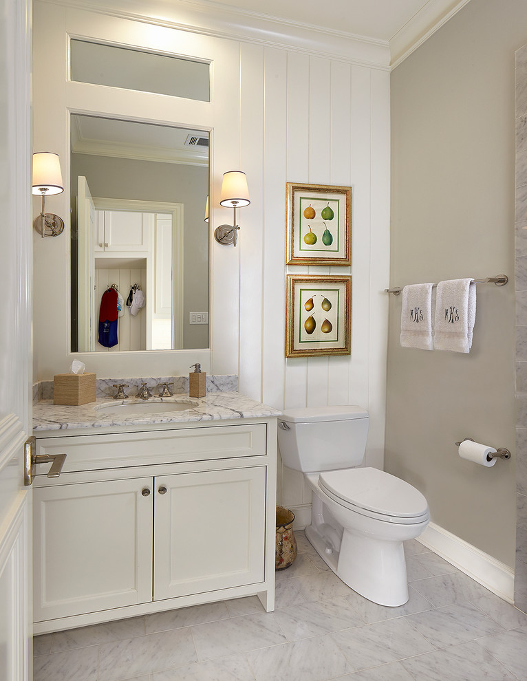 Inspiration for a small country powder room in Dallas with an undermount sink, white cabinets, marble benchtops, a two-piece toilet, grey walls, marble floors, recessed-panel cabinets, grey floor, white benchtops and white tile.