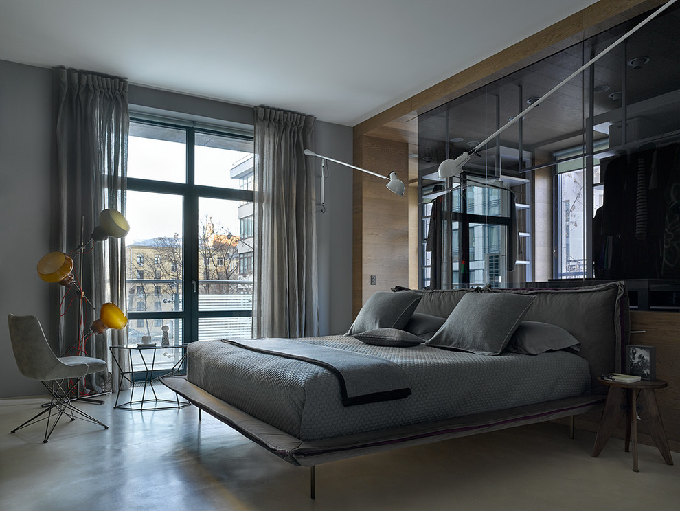 Large contemporary master bedroom in Moscow with grey walls, concrete floors and grey floor.