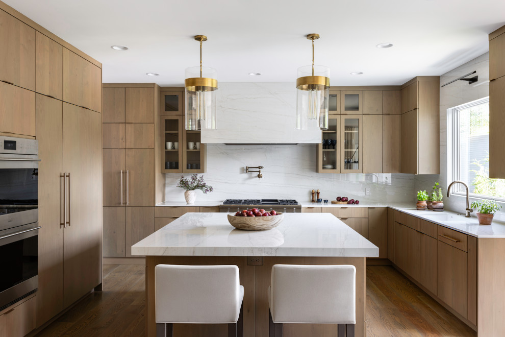 Inspiration for a large contemporary u-shaped light wood floor open concept kitchen remodel in DC Metro with an undermount sink, flat-panel cabinets, light wood cabinets, quartz countertops, white backsplash, quartz backsplash, paneled appliances, an island and white countertops