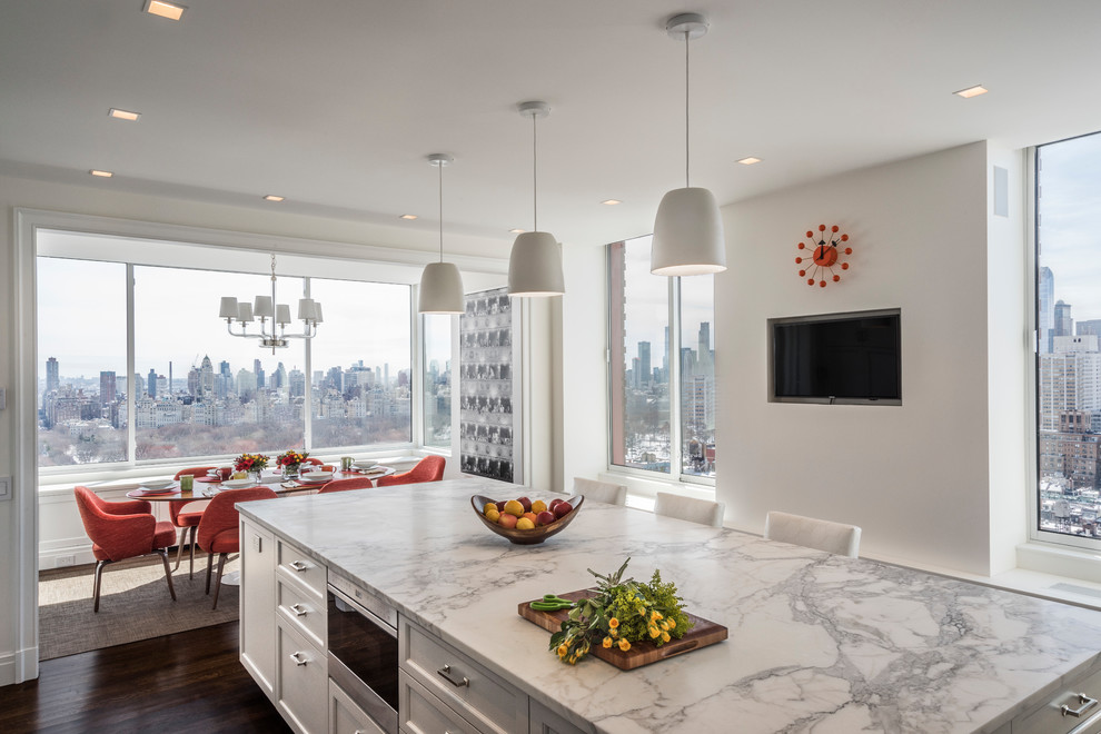 This is an example of an expansive transitional eat-in kitchen in New York with recessed-panel cabinets, grey cabinets, marble benchtops, stainless steel appliances, medium hardwood floors and brown floor.
