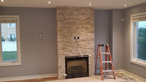 We just re-did the fireplace and planning to mount our TV on top. Our TV will be around 2" longer in length than the fireplace on each side. Would that look weird?  We also want your comments on how the colour of the wall with the colour of the stone fire