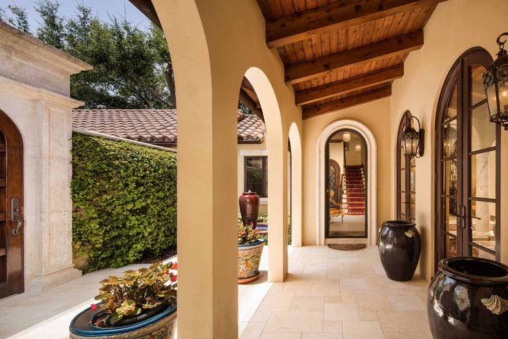 Mediterranean backyard verandah in Orlando with a water feature, natural stone pavers and a roof extension.