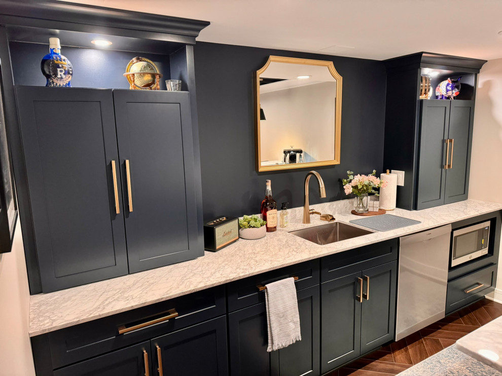 This is an example of a medium sized classic galley wet bar in Detroit with a submerged sink, shaker cabinets, blue cabinets, marble worktops, white splashback, marble splashback, vinyl flooring, brown floors and white worktops.