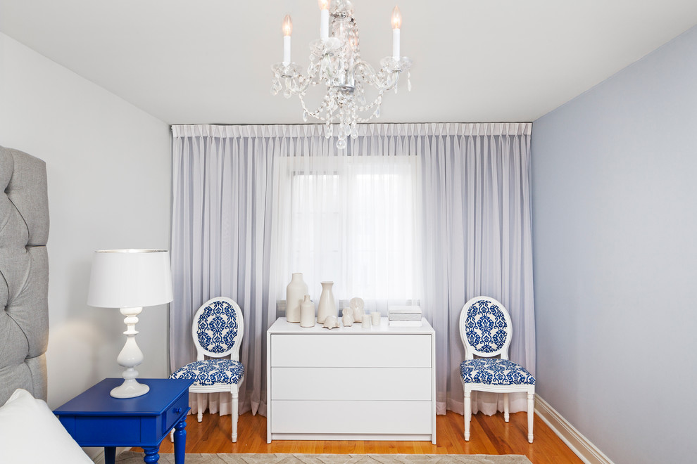 Inspiration for a mid-sized transitional master bedroom in Toronto with blue walls and medium hardwood floors.