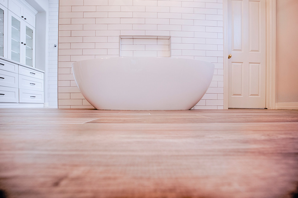 Example of a huge transitional master brown tile and porcelain tile porcelain tile freestanding bathtub design in Phoenix with shaker cabinets, white cabinets, a two-piece toilet, gray walls, an undermount sink and quartzite countertops