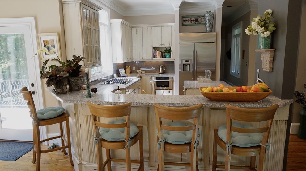Inspiration for a large rustic u-shaped medium tone wood floor eat-in kitchen remodel in Atlanta with an undermount sink, flat-panel cabinets, distressed cabinets, quartz countertops, white backsplash, ceramic backsplash, stainless steel appliances and beige walls