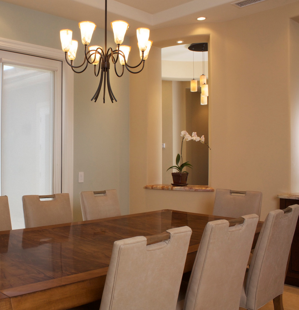 Medium sized contemporary dining room in Los Angeles with beige walls and limestone flooring.