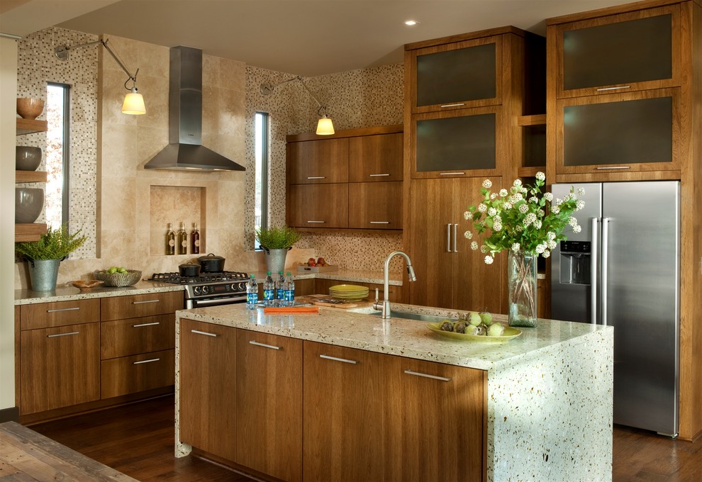 This is an example of a mid-sized transitional l-shaped eat-in kitchen in Atlanta with stainless steel appliances, an undermount sink, flat-panel cabinets, medium wood cabinets, recycled glass benchtops, beige splashback, mosaic tile splashback, dark hardwood floors, with island and brown floor.